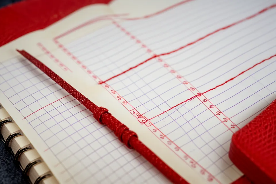 Handwritten EuroMillions frequency notes compared with an AI lottery tool's number picks
